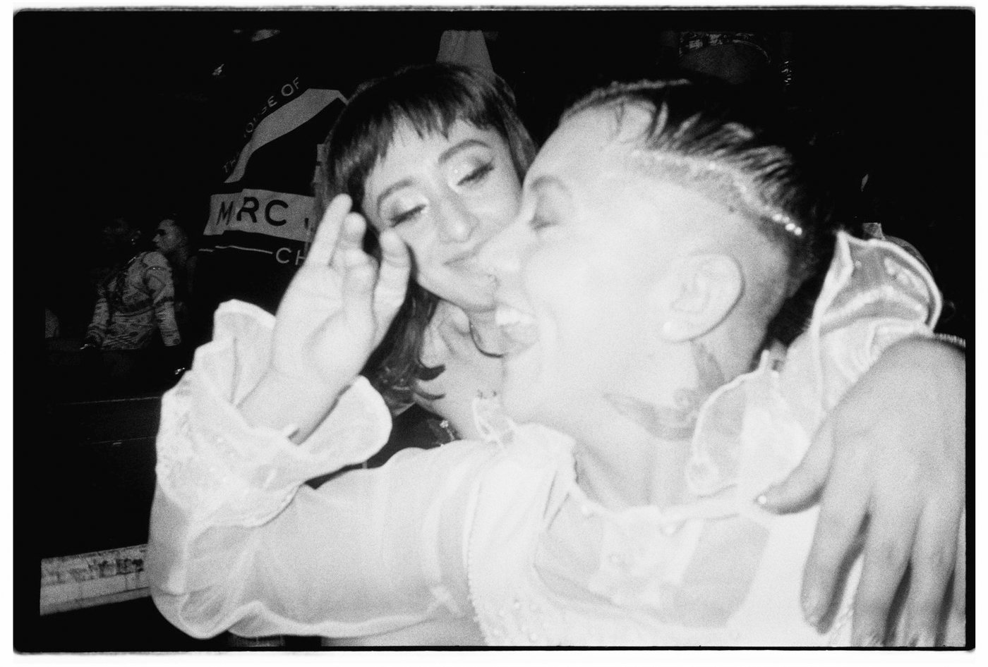 Two people embracing and laughing in black and white