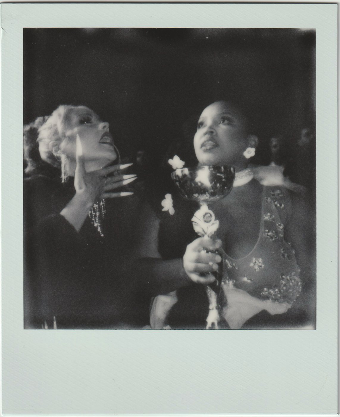 Two people looking up, one holding a trophy